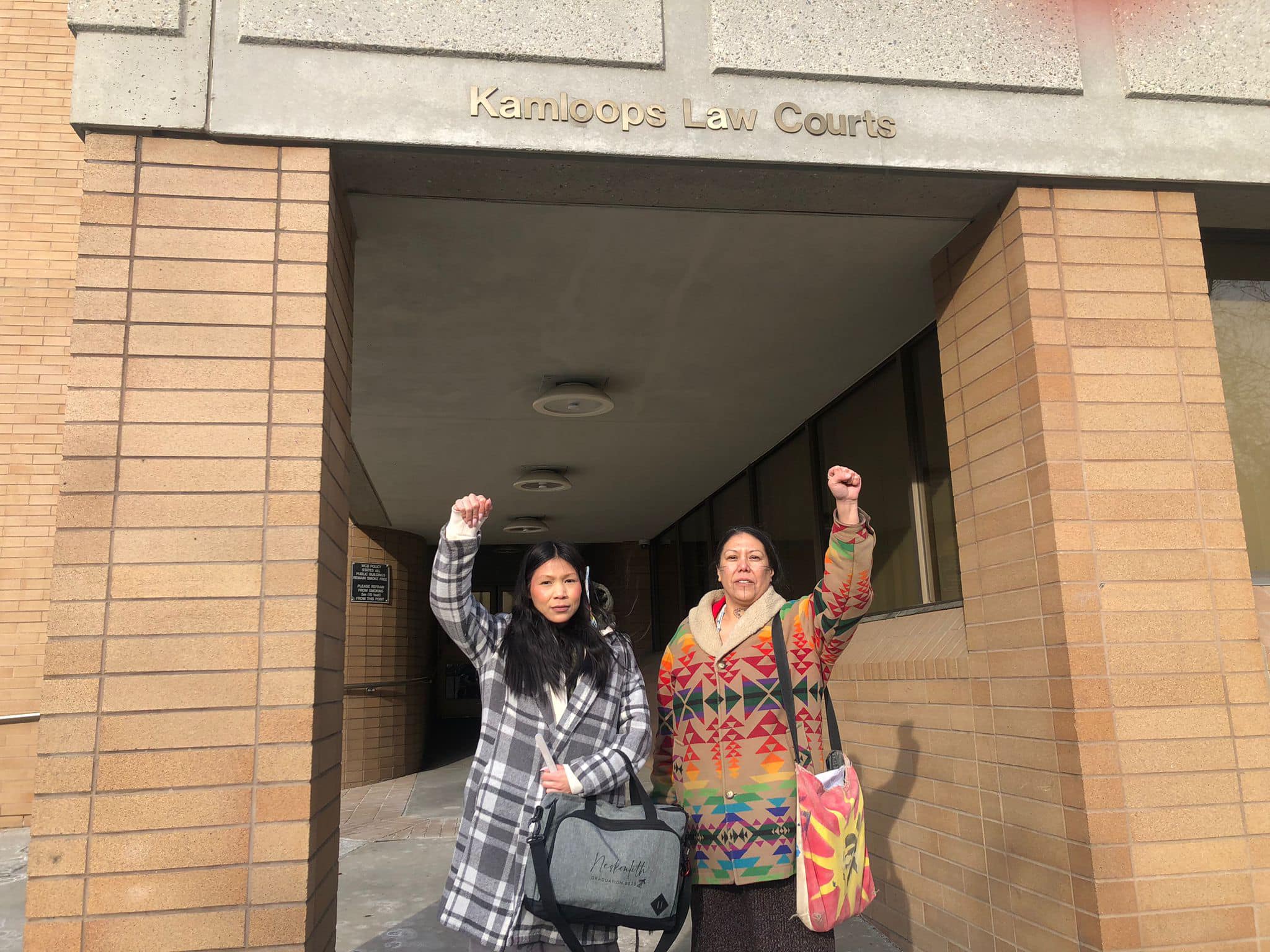 Tiny House Warriors members Tricia Charlie, left, and Mayuk (Nicole) Manuel stand outside of Kamloops Law Courts during sentencing proceedings against them earlier this month. Photo courtesy Tiny House Warriors/Facebook