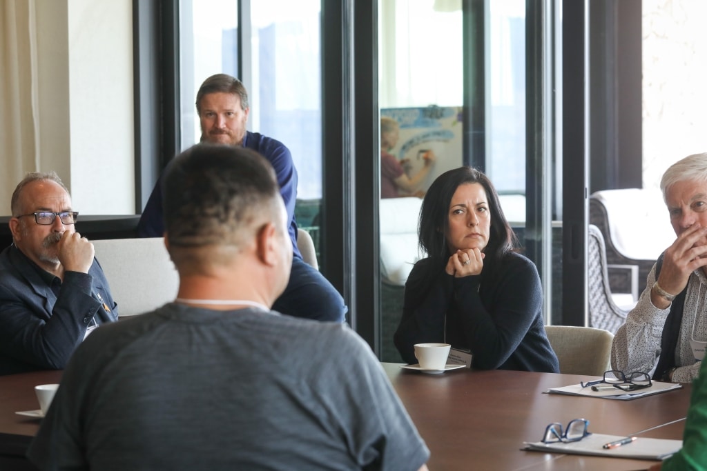 Members of the Okanagan-Similkameen Collaborative Leadership Table participate in discussions during the group’s April 24 meeting in the District of Lake Country, in syilx territory. From left to right: Tim Roberts, regional district of Okanagan-Similkameen; Jason Wiebe (background), Mayor of Keremeos; Tim Lezard (foreground), Penticton Indian Band councillor; Petra Veintimilla, Town of Oliver councillor; and Julius Bloomfield, Mayor of Penticton. Photo by Aaron Hemens